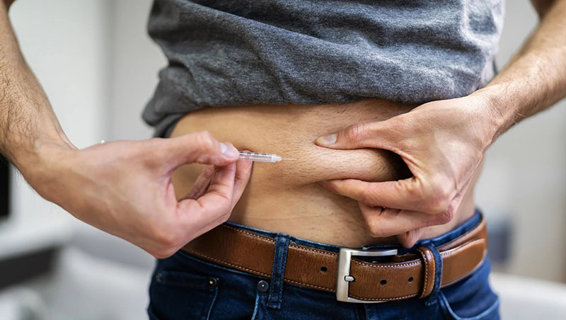 A person doing a TRT self-injection.